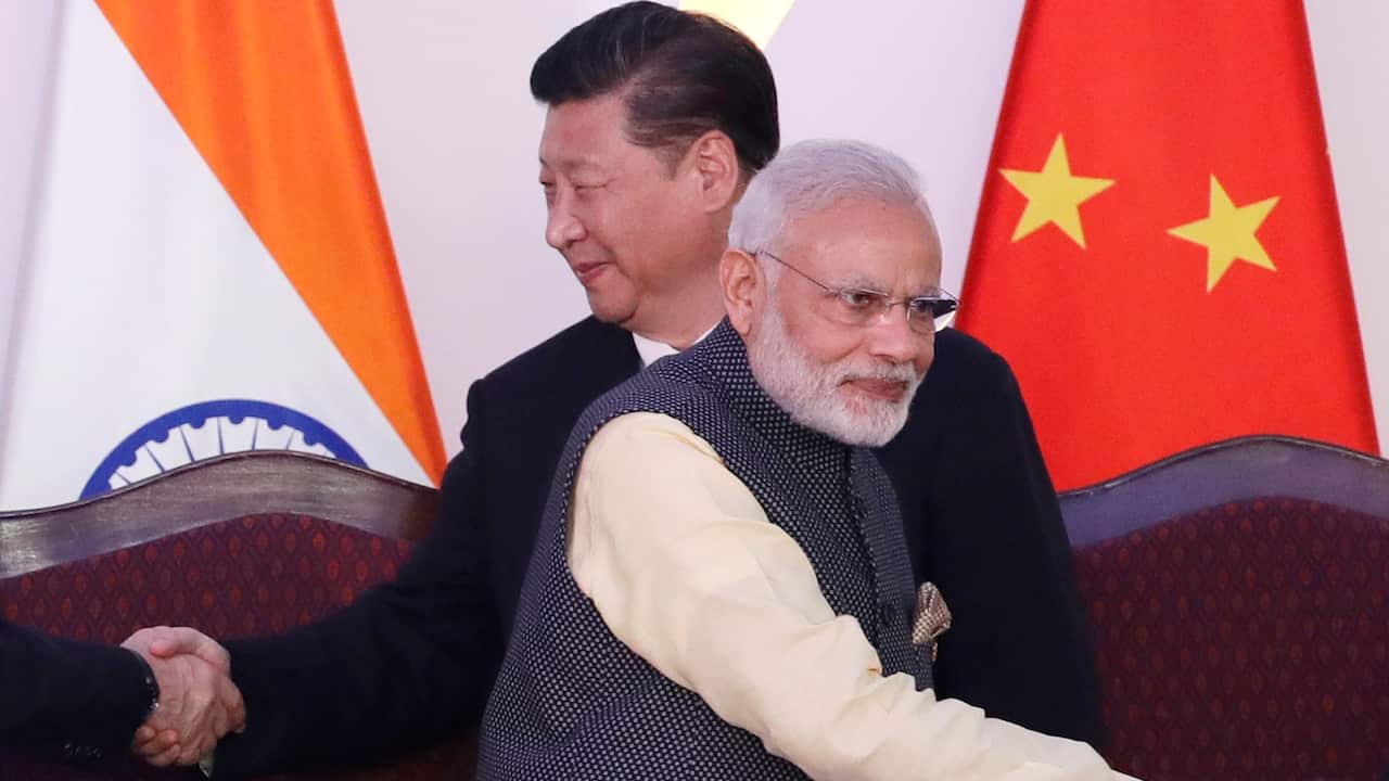 In this Oct. 16, 2016, file photo, Indian Prime Minister Narendra Modi, front and Chinese President Xi Jinping shake hands with leaders at the BRICS summit in Goa, India. Tensions along the China-India border high in the Himalayas have flared again in rec