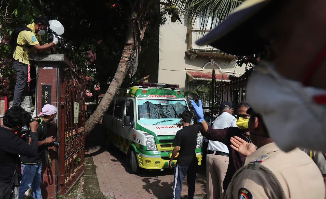 An ambulance carrying the body of Bollywood actor Sushant Singh Rajput leaves from the building he lived in Mumbai, India, Sunday, June 14, 2020.