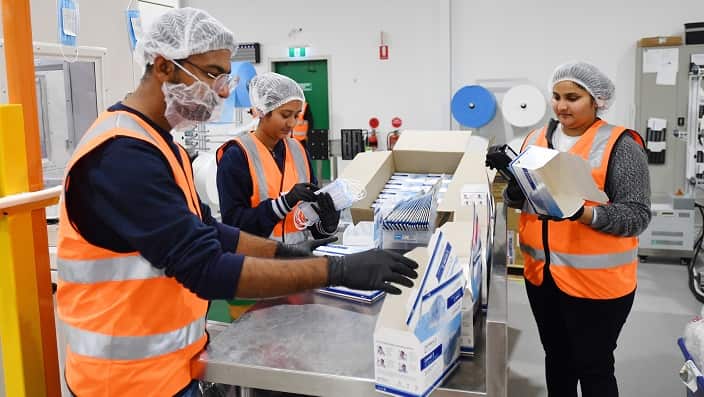 Employees on the production line of the Detmold PPE production facility in Brompton, Adelaide.