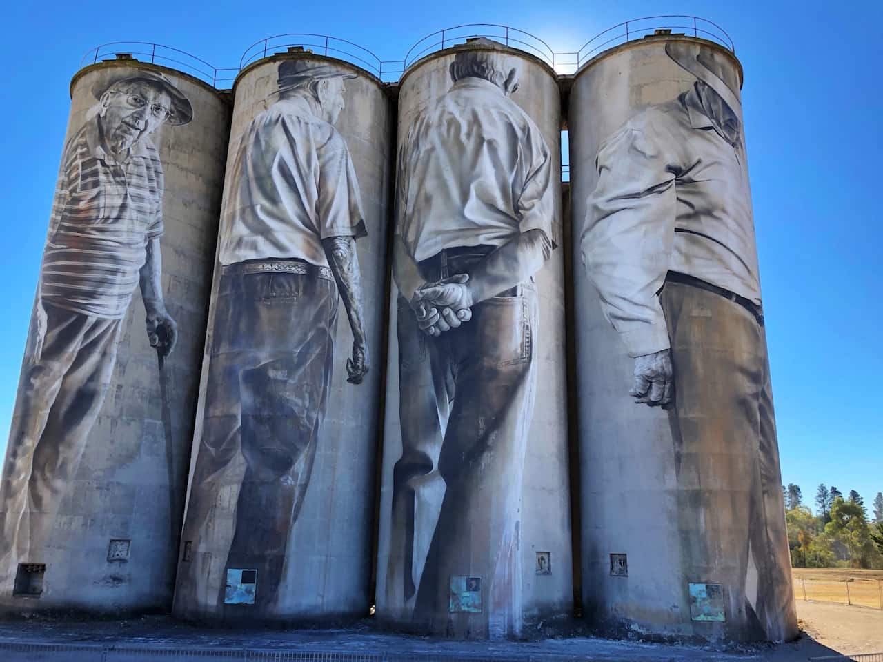 Portland Silo Art - New South Wales. The old Portland Cement Works were painted by Guido van Helten and depict five male and one female past Portland Cement workers.