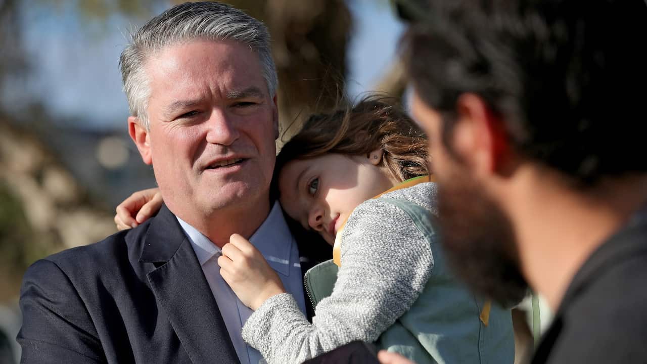 Australian Finance Minister Mathias Cormann is seen during a press conference with his daughter Isabelle to announce his resignation in Perth, jULY 2020.