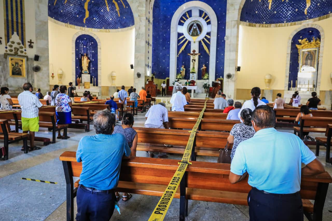 People attend mass with sanitary measures, after three months of the religious centers being closed due to the COVID-19 pandemic, in Acapulco, Guerrero State, Mexico, 05 July 2020.  EPA/David Guzman