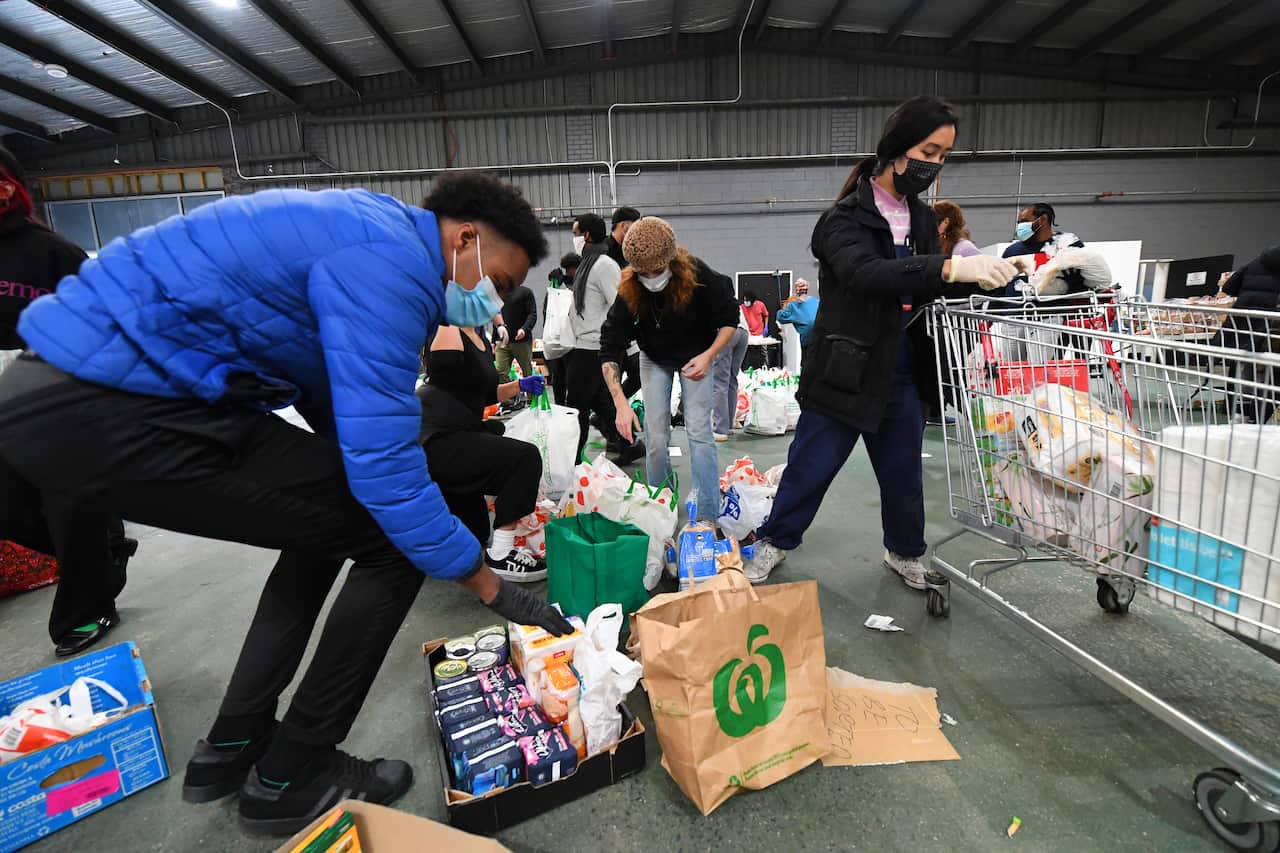Volunteers scramble to organise food and personal hygiene supplies at the Australian Muslim Social Services Agency in North Melbourne, Monday, July 6, 2020. 