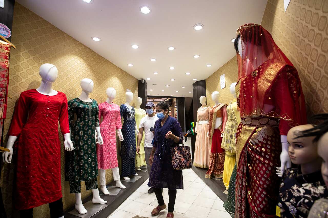 A woman wearing a face mask walks inside a reopened shopping mall, as the lockdown came to an end.