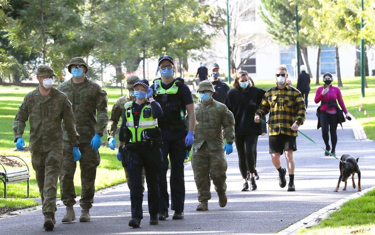 ADF personnel and Victorian police officers are seen patrolling Fitzroy Gardens in Melbourne, Saturday, July 25, 2020.     