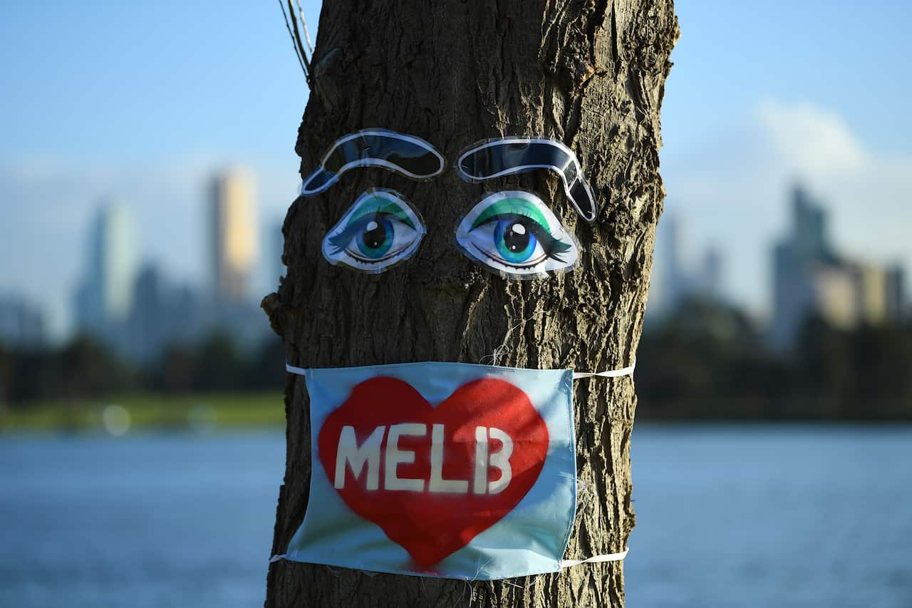 Coronavirus inspired art is seen attached to a tree near Albert Park in Melbourne, Wednesday, August 5, 2020.