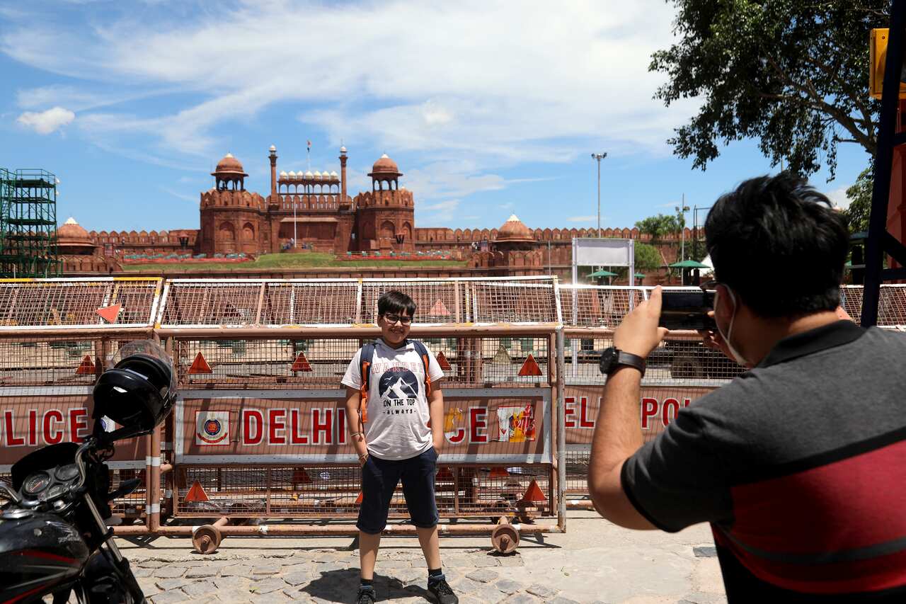 A visitor takes photographs at the Red Fort as preparation are underway on full swing ahead of upcoming Independence Day celebrations.