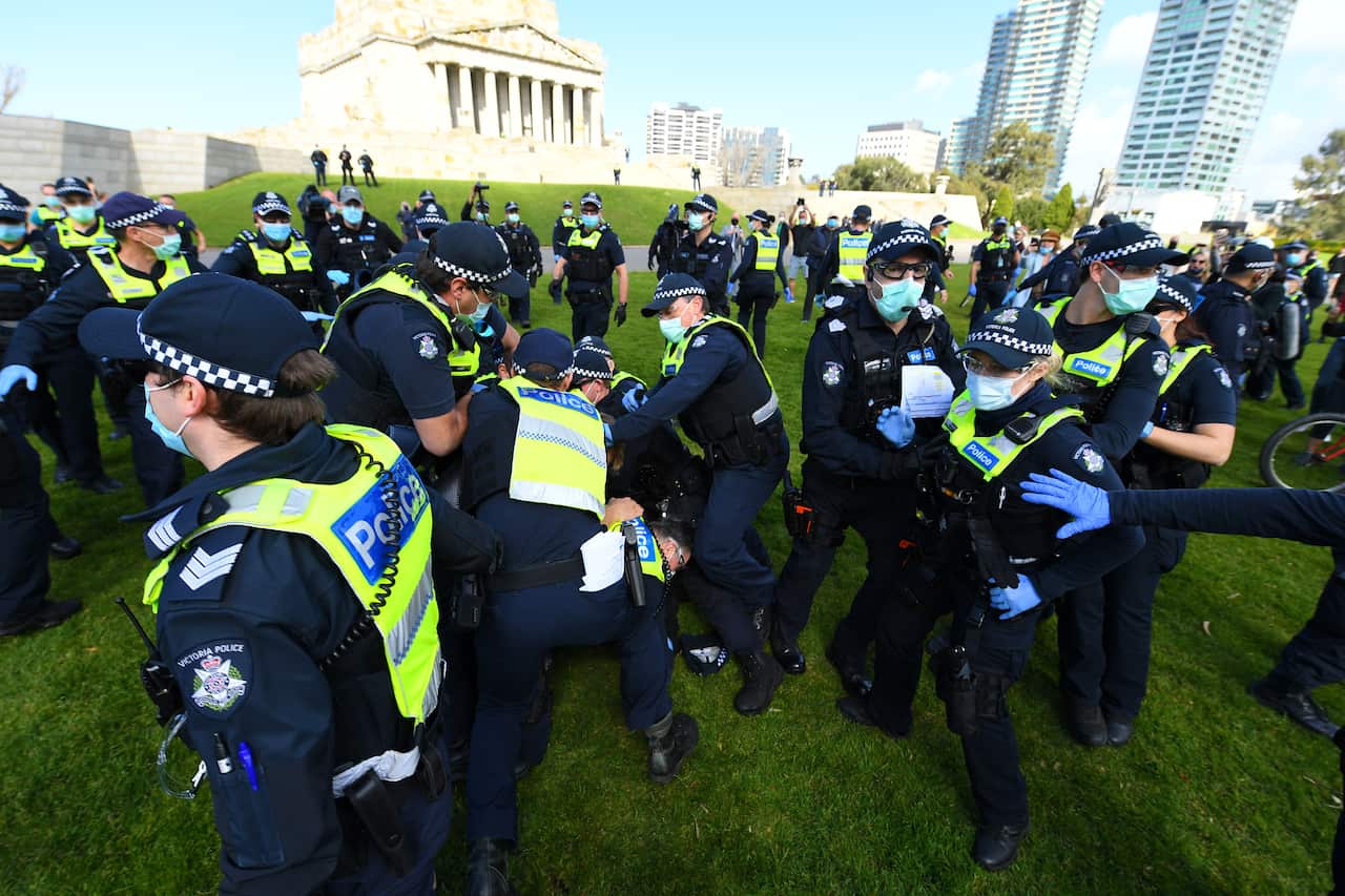 A Protester scuffles with with Police outside of the Shrine of Remembrance in Melbourne, Saturday, September 5, 2020.