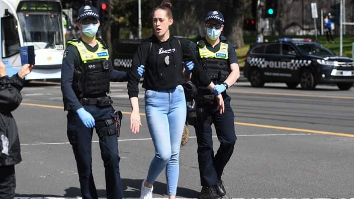 Police arrest a protester during an anti-lockdown protest in Melbourne, Sunday, September 13, 2020.