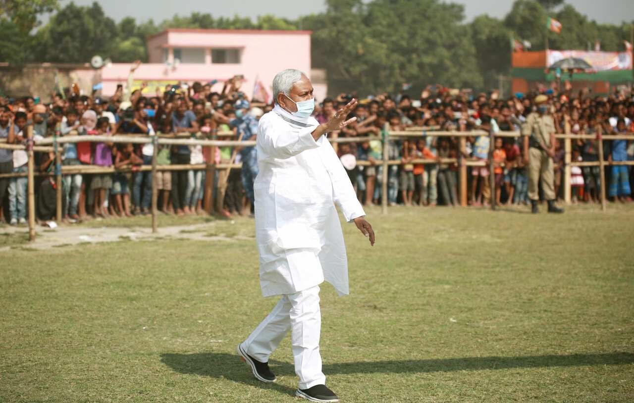 Bihar Chief Minister Nitish Kumar gestures towards the crowd at an election rally