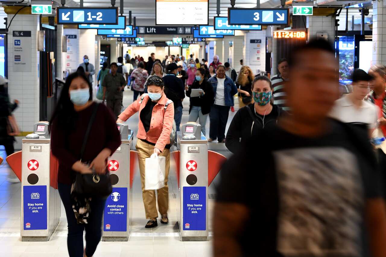 Commuters are seen at Town Hall station in Sydney, Tuesday, November 10, 2020.