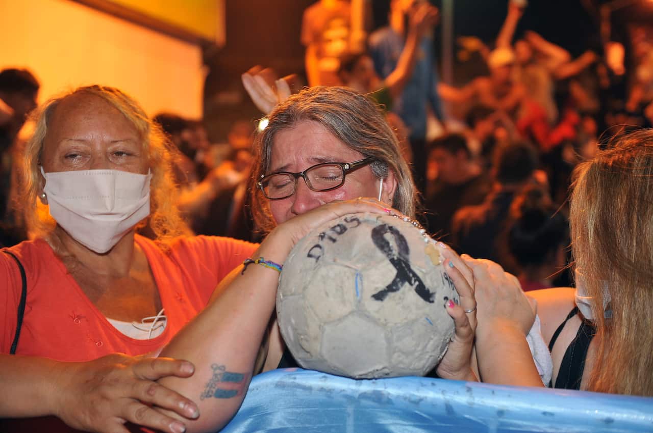 Supporters of former soccer player Diego Maradona gather at the door of the judicial morgue, in the town of San Fernando, Buenos Aires province