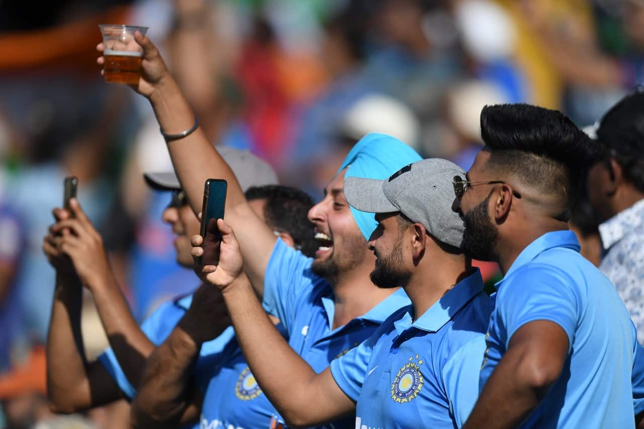 Indian supporters celebrate after taking the wicket of David Warner at the SCG in Sydney, Friday, November 27, 2020. 