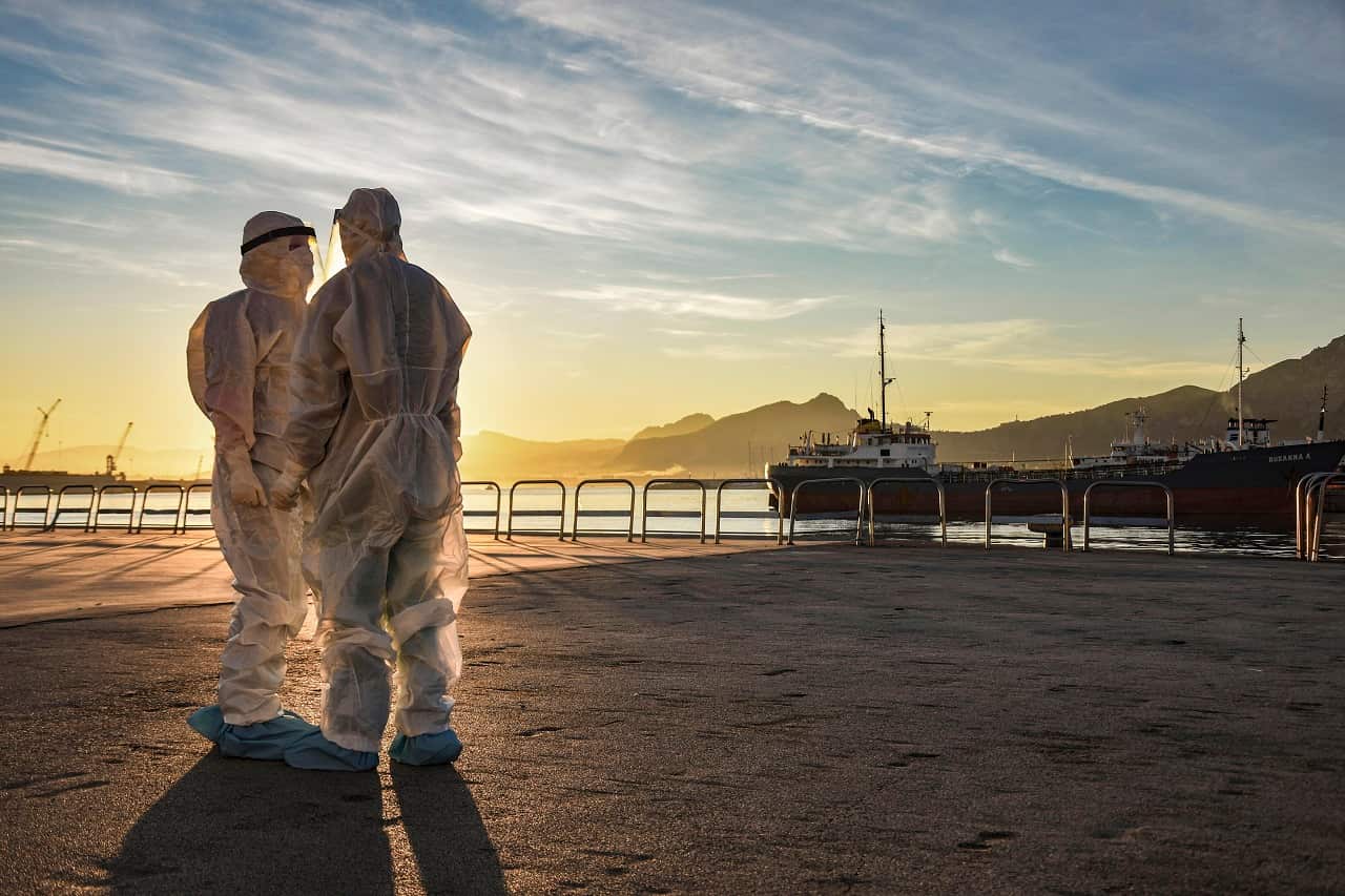 Medical staff members waits to test for COVID-19 passengers arriving at Palermo harbor, Sicily, southern Italy, Tuesday, Dec. 15, 2020. 