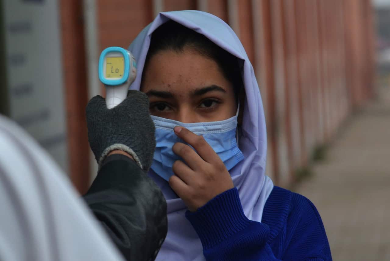 Pakistani students wearing facemasks to attend their first day of school with SOP's, at govt kinnaird high school in Lahore.