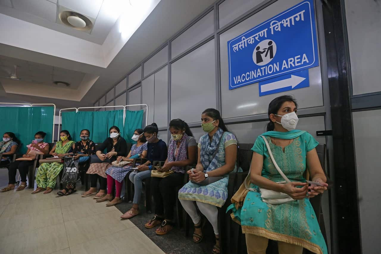 People wait for their turn to be vaccinated against COVID-19 inside the vaccination centre at Shatabdi Hospital in Mumbai, India, 30 January 2021.  