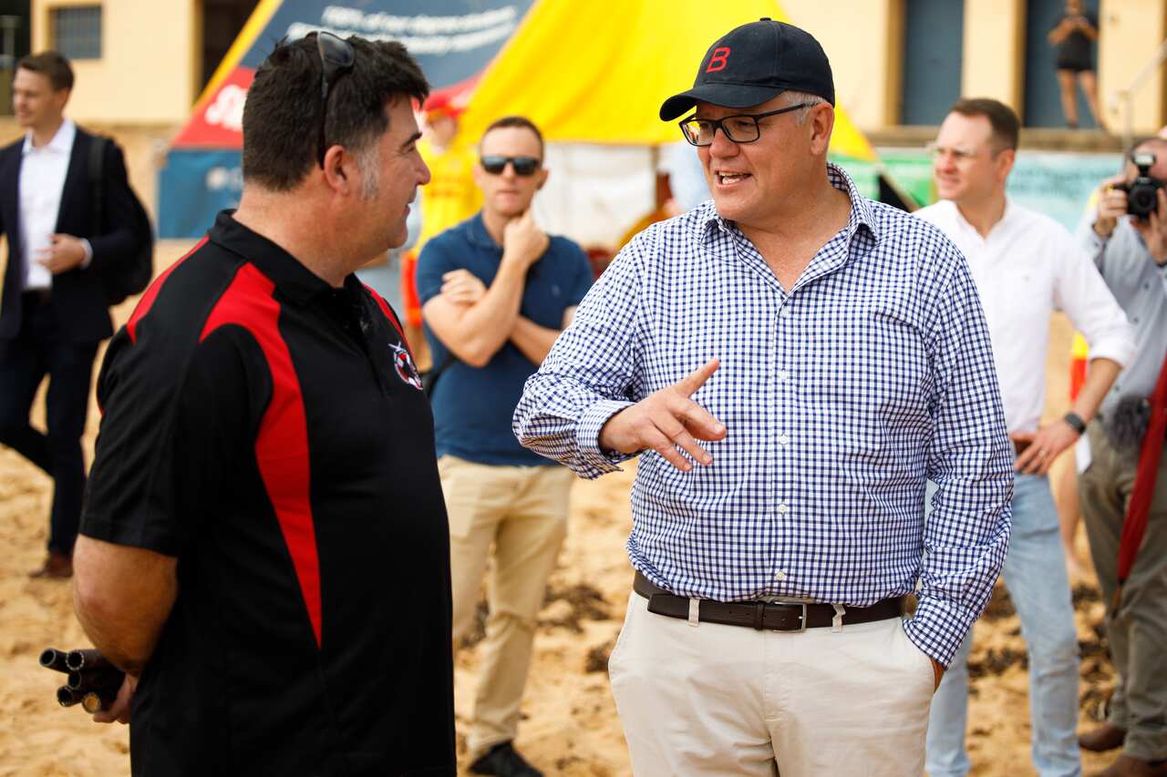 Australian Prime Minister Scott Morrison (right) is seen at the Collaroy Surf Life Saving Club in Sydney, Saturday, February 20, 2021. (AAP Image/Paul Braven) NO ARCHIVING