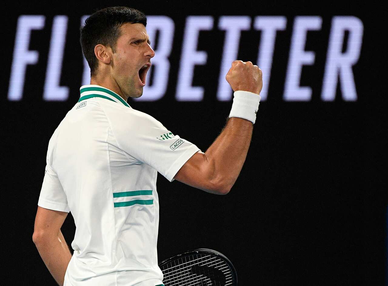 Serbia's Novak Djokovic reacts after winning a point against Russia's Daniil Medvedev in the men's singles final at the Australian Open tennis championship in Melbourne, Australia, Sunday, Feb. 21, 2021.(AP Photo/Andy Brownbill)