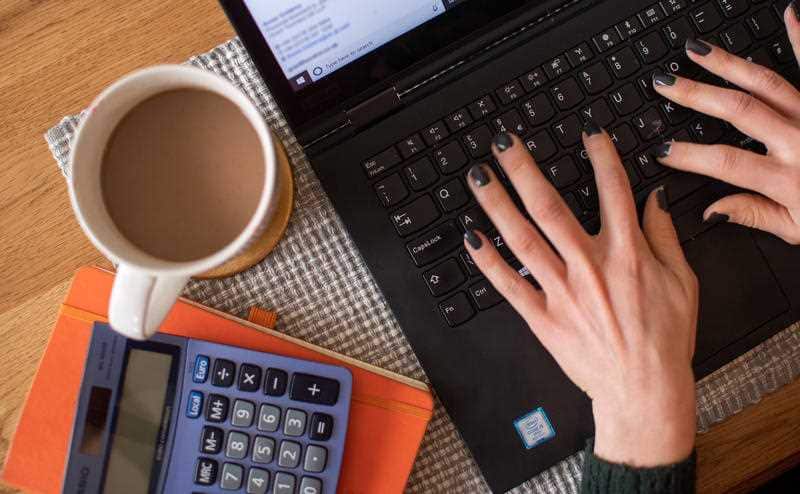 A woman using a laptop on a dining room table set up as a remote office to work from home. The coronavirus pandemic has dramatically altered the way people have lived their lives over the past year.