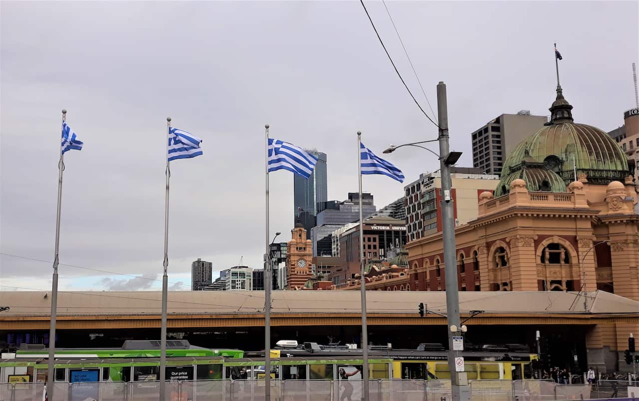 Greek flags flying high in Melbourne's most iconic square, Federation Square.