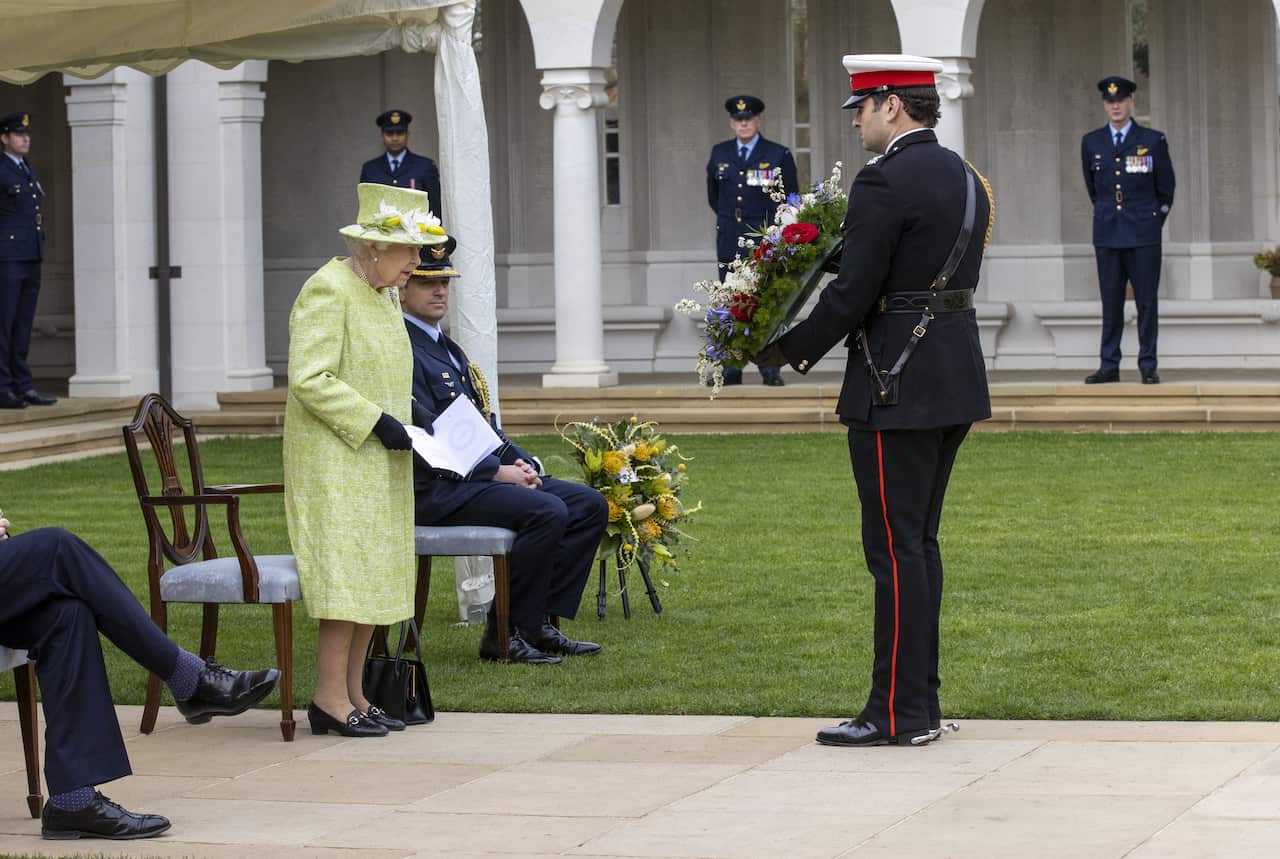 Queen Elizabeth II inspects a wreath during a service to mark the Centenary of the Royal Australian Air Force at the CWGC Air Forces 