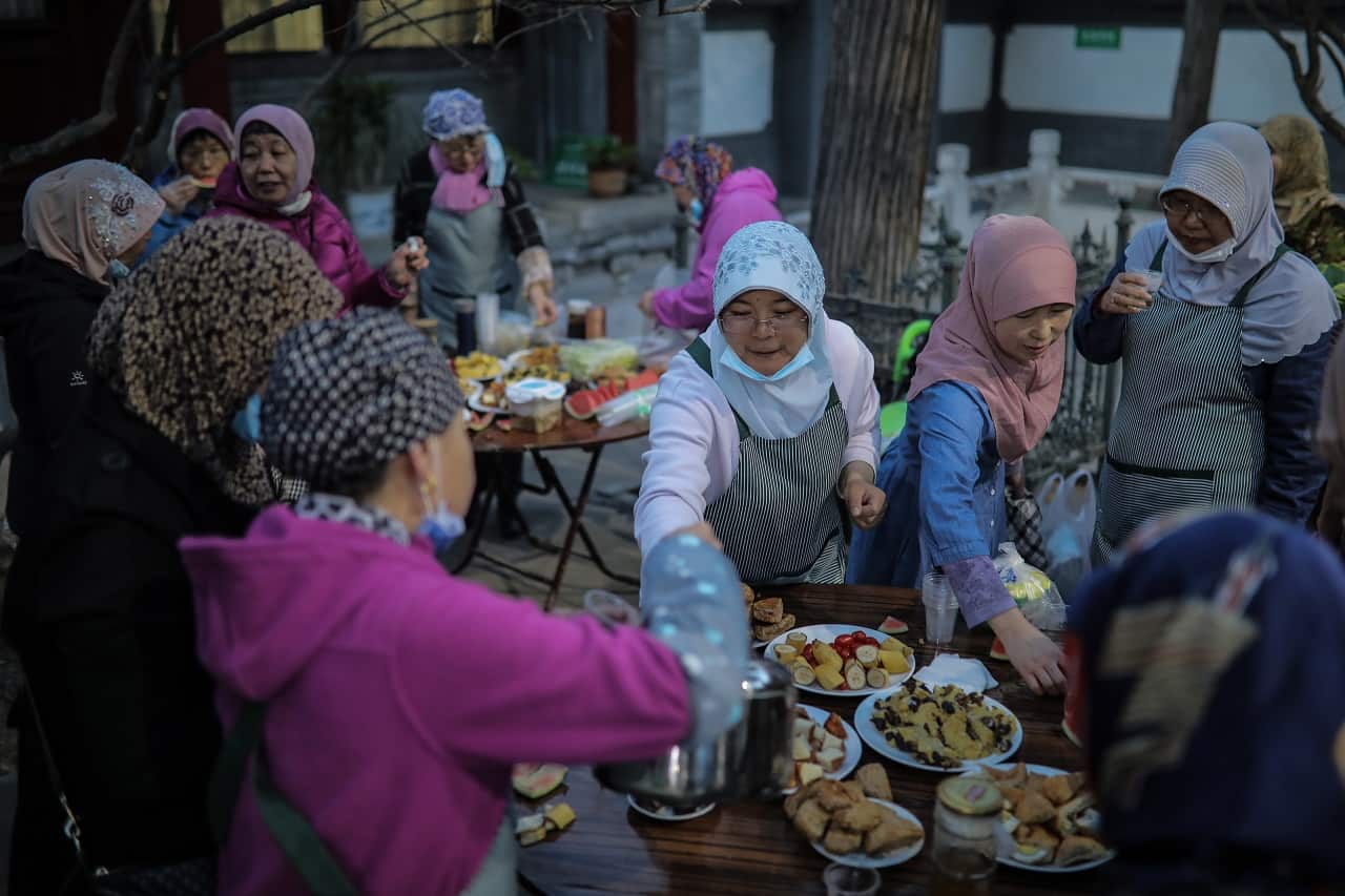 Muslims break fast with other devotees on the first day of the fasting month of Ramadan at the Niujie Mosque in Beijing city, China, 13 April 2021. 