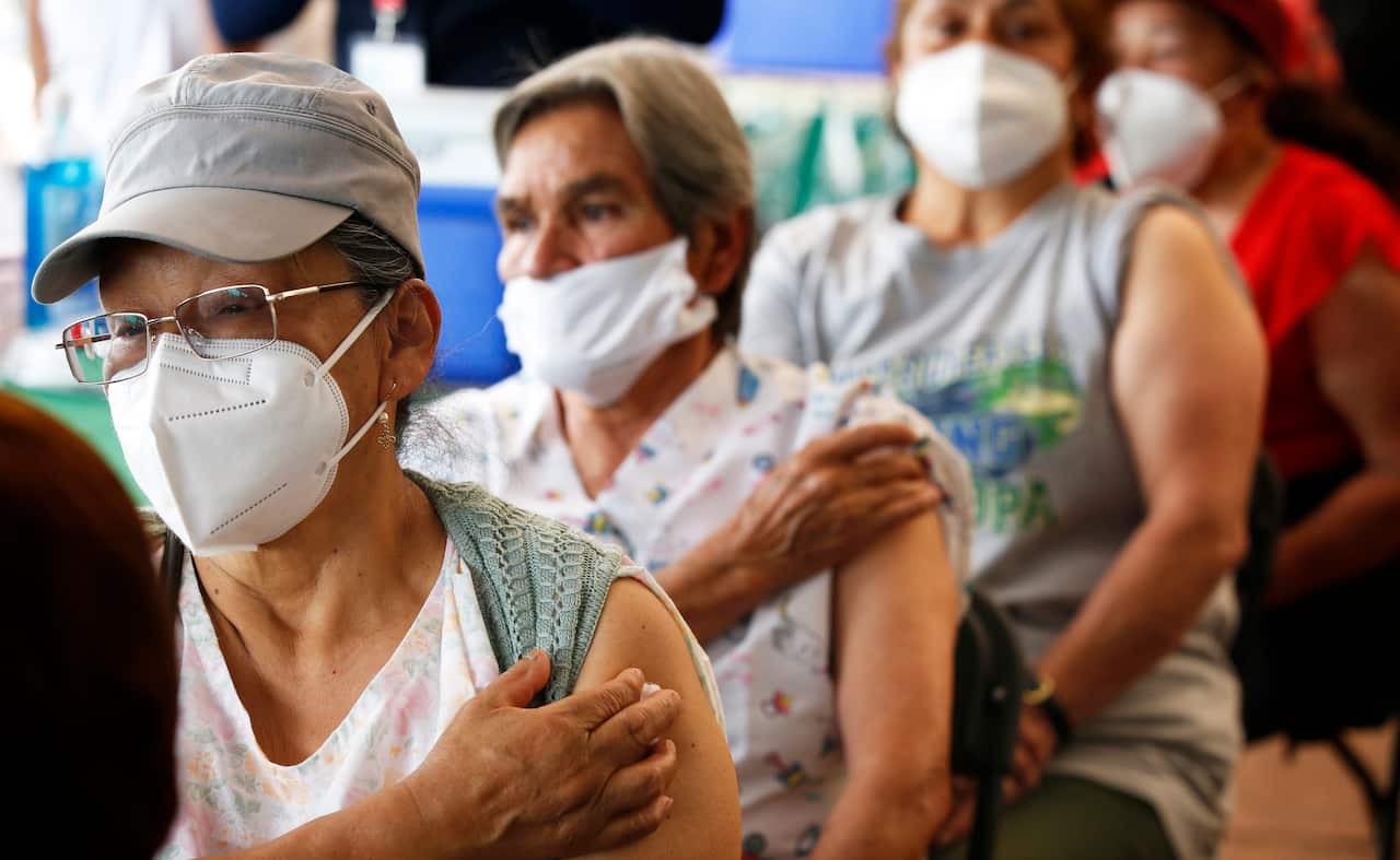 Persons over 60-years-old wait in observation after receiving their second dose of the AstraZeneca COVID-19 vaccine at the University Olympic Stadium in Mexico City, Monday, April 12, 2021. (AP Photo/Marco Ugarte)