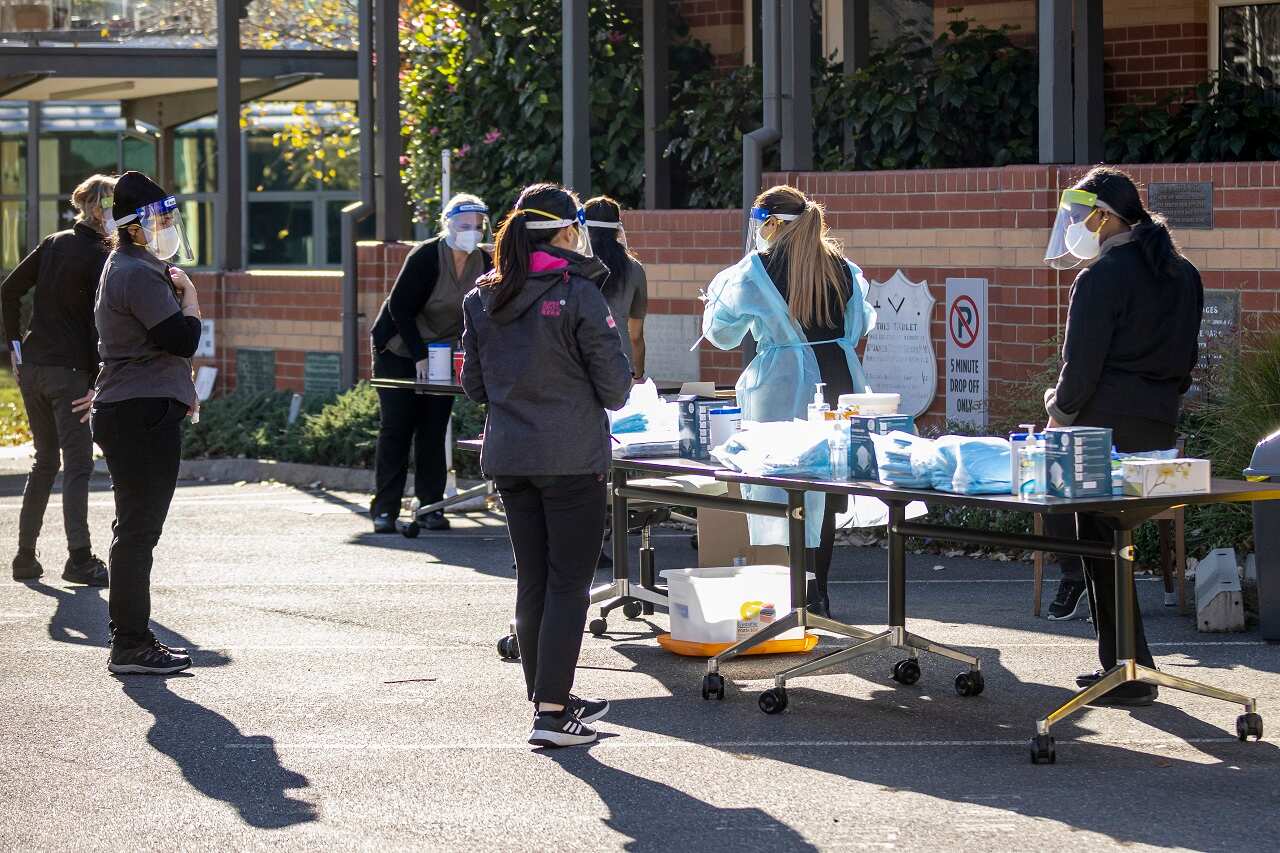 Staff members of the Royal Freemasons Coppin Centre receive COVID tests in the carpark, in Melbourne, Monday, May 31, 2021. (AAP Image/Daniel Pockett) NO ARCHIVING