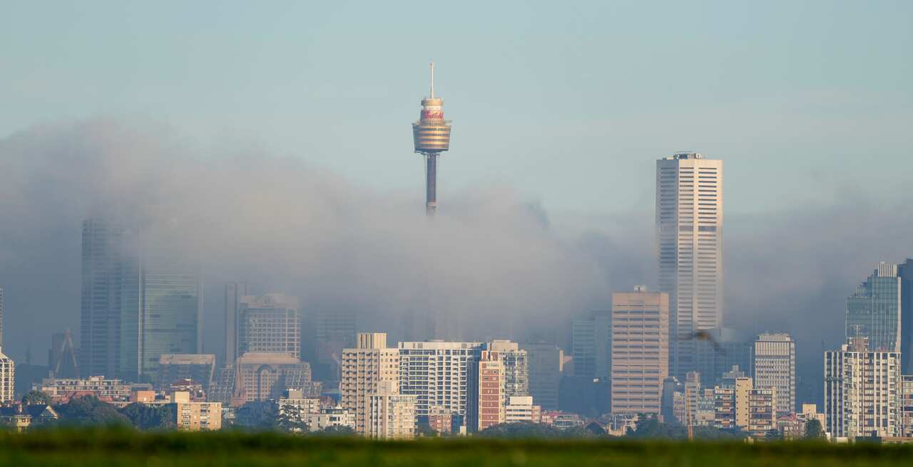 Fog drifts through the buildings in Sydneys central business district, Australia, Friday, June 11, 2021. The Fog on Sydney Harbour delayed some harbour ferry services and a road weather alert was issued by the Bureau of Meteorology for hazardous driving c