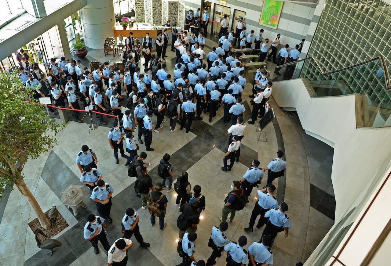 Police officers gather at the lobby of headquarters of Apple Daily in Hong Kong Thursday, June 17, 2021. Hong Kong police on Thursday morning arrested the chief editor and four other senior executives of Apple Daily under the national security law on susp