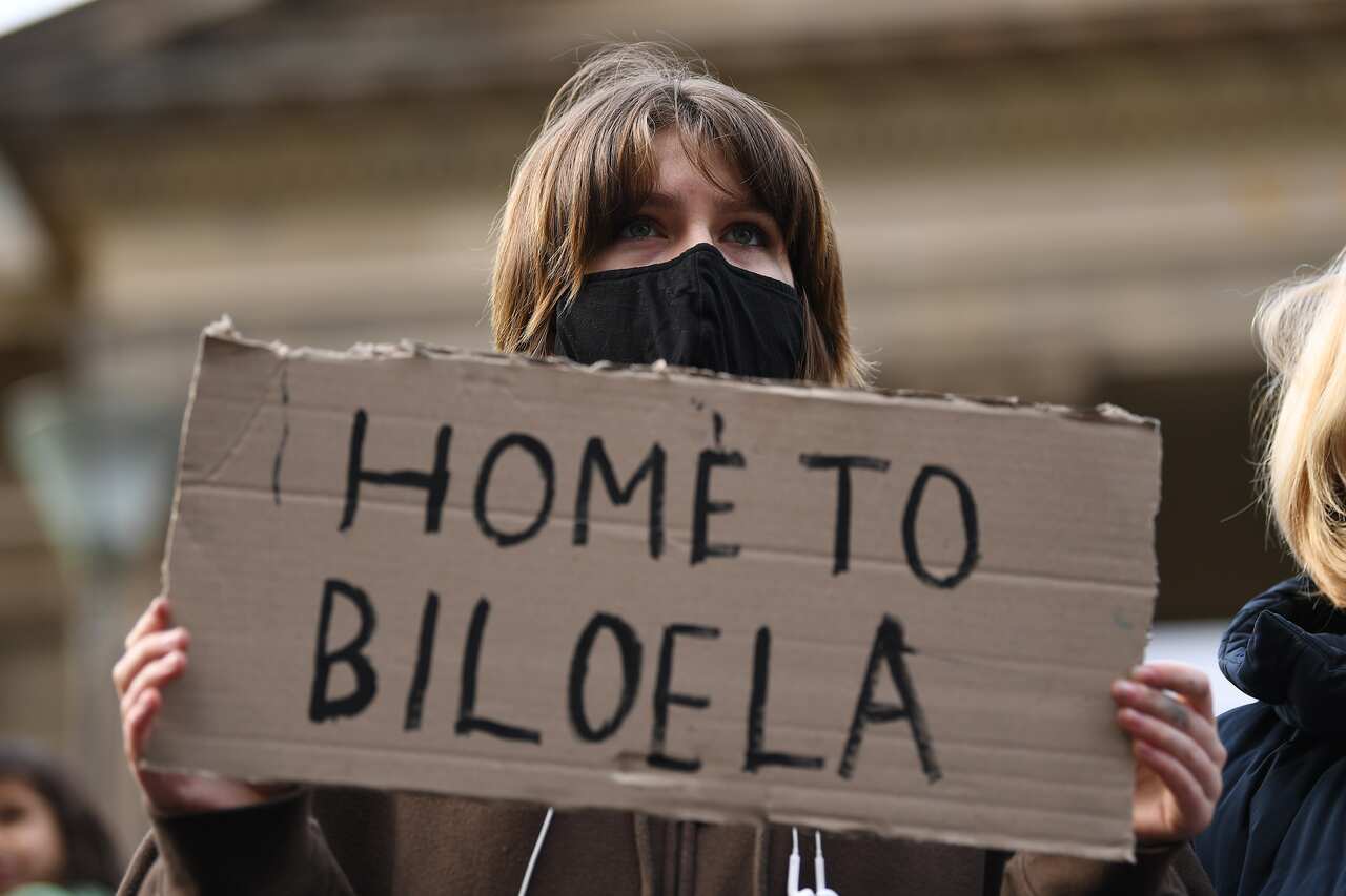 Protesters are seen during a rally at the State Library of Victoria in Melbourne, Saturday, June 19, 2021. A rally is being held in Melbourne against the federal government's decision not to allow the Murugappan family to return to Biloela in central Quee
