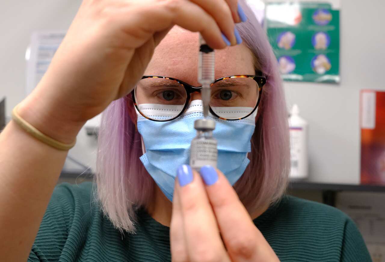 Medical staff at Midtown Medical Clinic prepare the Pfizer vaccine, Monday, July 5, 2021.