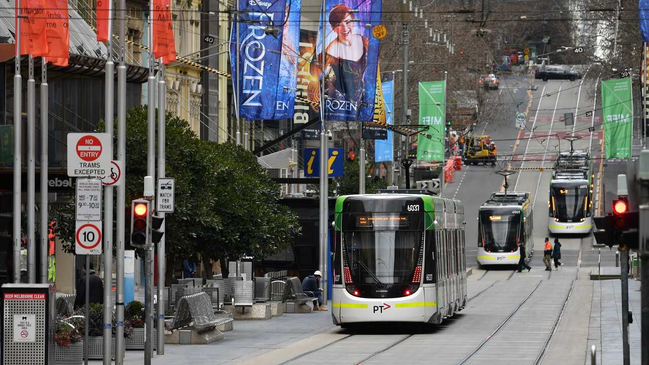 Trams are seen along Bourke Street in Melbourne, Friday, July 23, 2021.