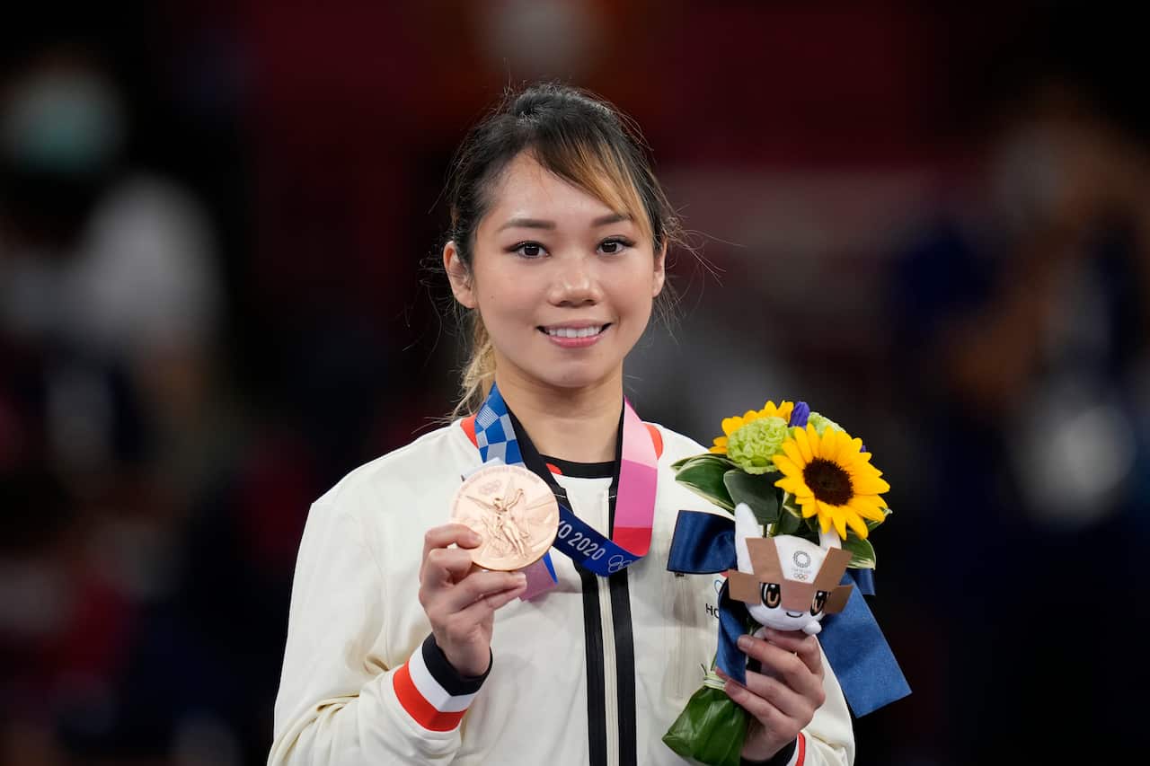Bronze medalist Lau Mo Sheung Grace of Hong Kong poses with her medal in the award ceremony for the women's kata for Karate at the 2020 Summer Olympics, Thursday, Aug. 5, 2021, in Tokyo, Japan. (AP Photo/Vincent Thian)