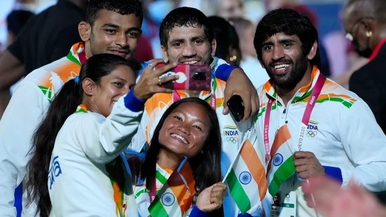 Athletes from India take a selfie during the closing ceremony in the Olympic Stadium at the 2020 Summer Olympics, Sunday, Aug. 8, 2021, in Tokyo, Japan. 