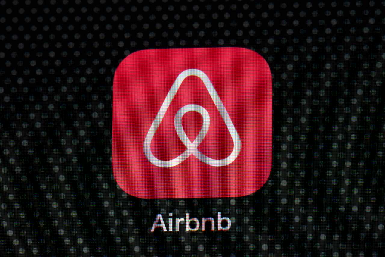 FILE - In this Saturday, May 8, 2021, file photo, the Airbnb app icon is seen on an iPad screen, in Washington. Airbnb said Thursday, Aug. 12, 2021, that it narrowed its second-quarter loss to $68 million and saw an increase in bookings, but the company w