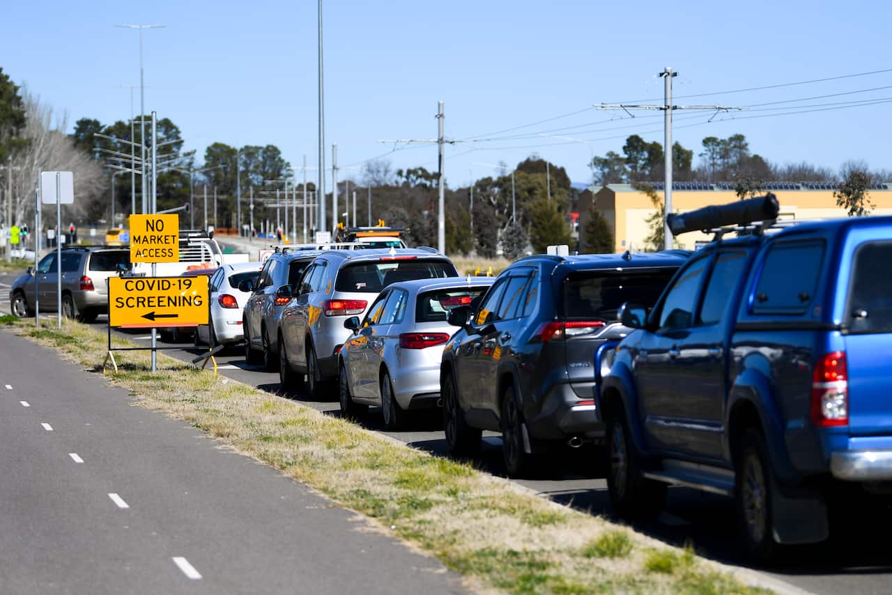Cars form long cues as residents wait to be tested at the EPIC Drive-through COVID19 testing site in Canberra, Friday, August 13, 2021.