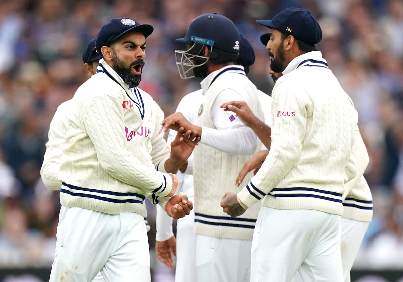 Indian skipper Virat Kohli celebrates catching the ball from England's Joe Root 
