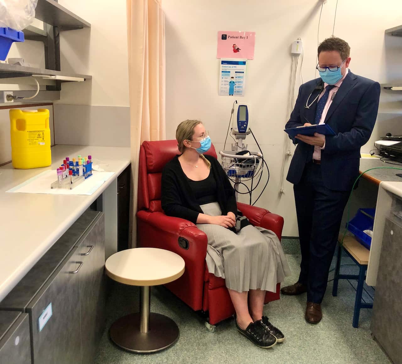 A supplied undated image obtained Thursday, August 19, 2021 shows Dr Paul Griffin (right) with a patient at Mater Hospital in Brisbane. (AAP Image/Supplied by Mater Research) NO ARCHIVING, EDITORIAL USE ONLY