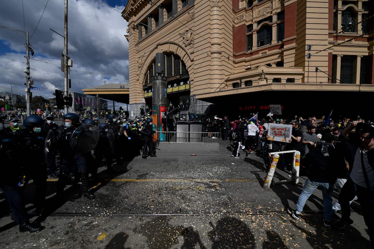 Protesters are pepper sprayed by police during an anti-lockdown protest in the central business district of Melbourne.