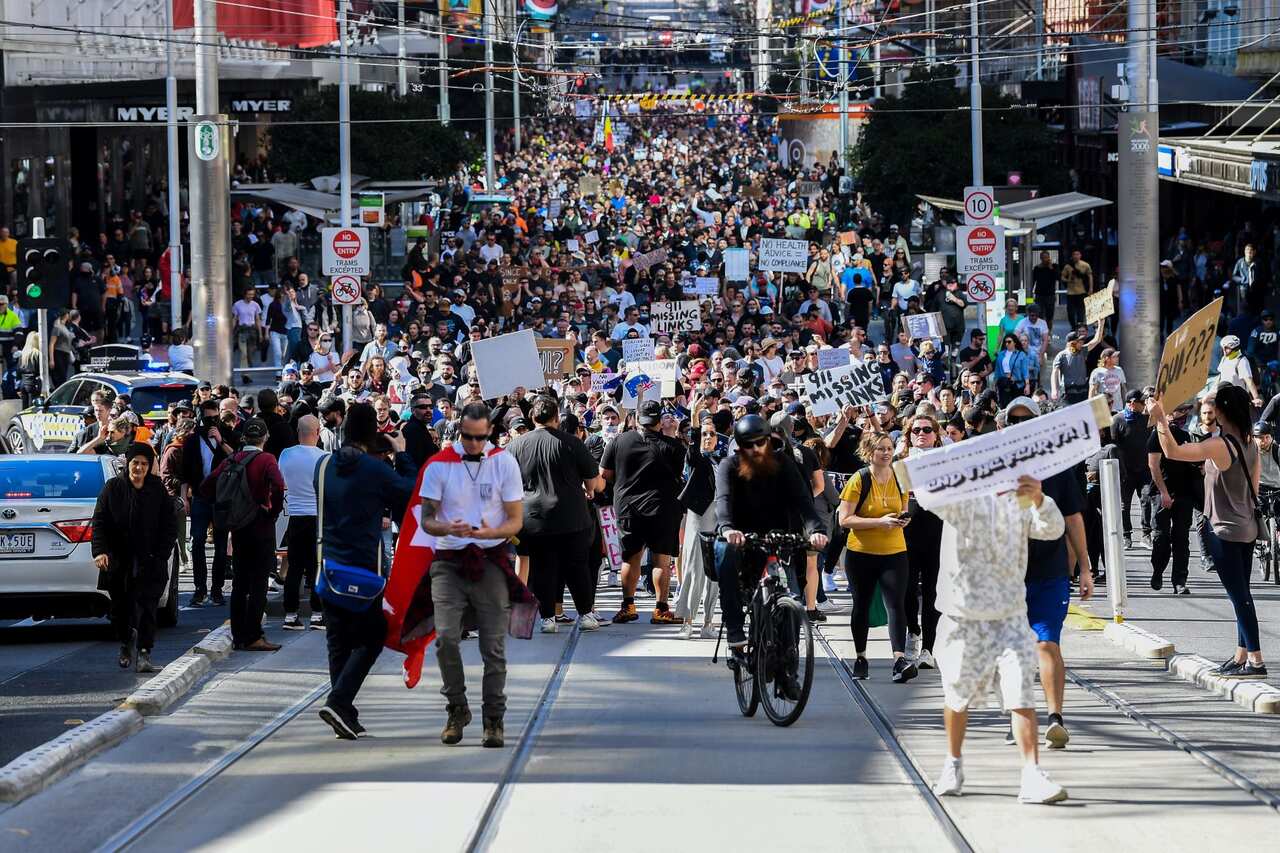 Protesters gather for a 'National Rally for Peace, Freedom and Human Rights' anti-lockdown protest in Melbourne, Saturday