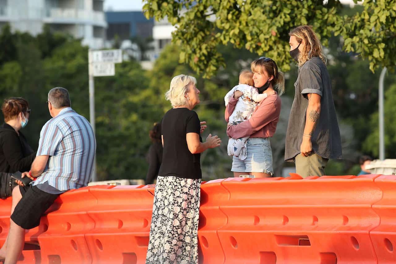 People talk to each other over the barriers at the QLD/NSW border, Tweed Heads, Gold Coast, 