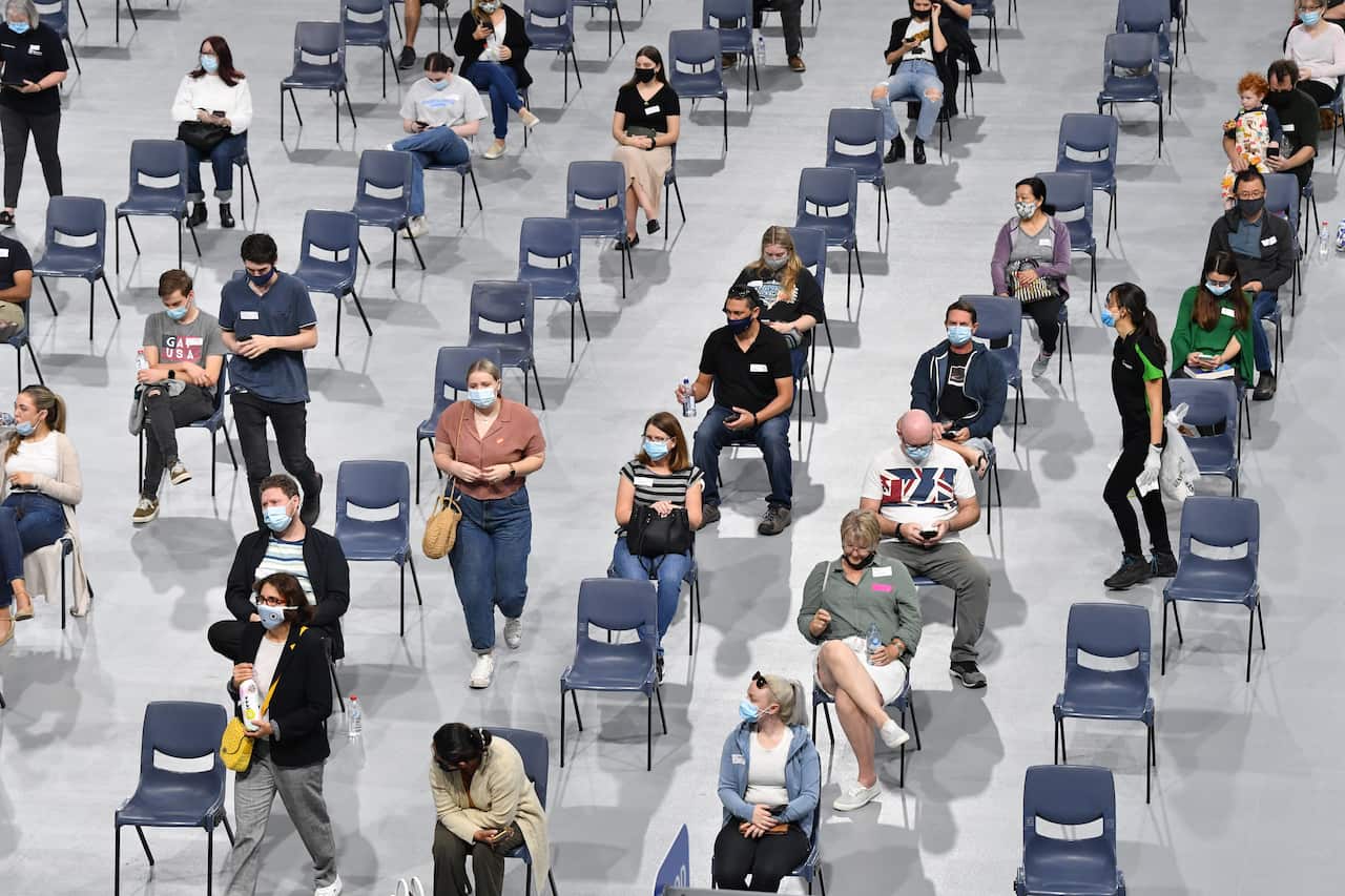 People are seen in the waiting area after receiving their COVID-19 vaccination at the new mass Boondall Vaccination Centre Brisbane. 