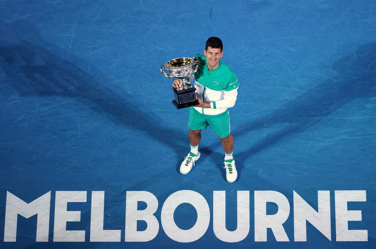 Serbia's Novak Djokovic holds the Norman Brookes Challenge Cup after defeating Russia's Daniil Medvedev in the men's singles final at the 2021 Australian Open 