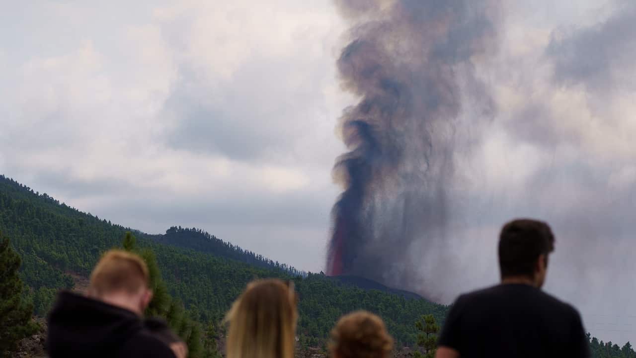 People look at the smoke rising up from the new 'Cumbre Vieja' volcano in La Palma, Canary islands, Spain, 20 September 2021.