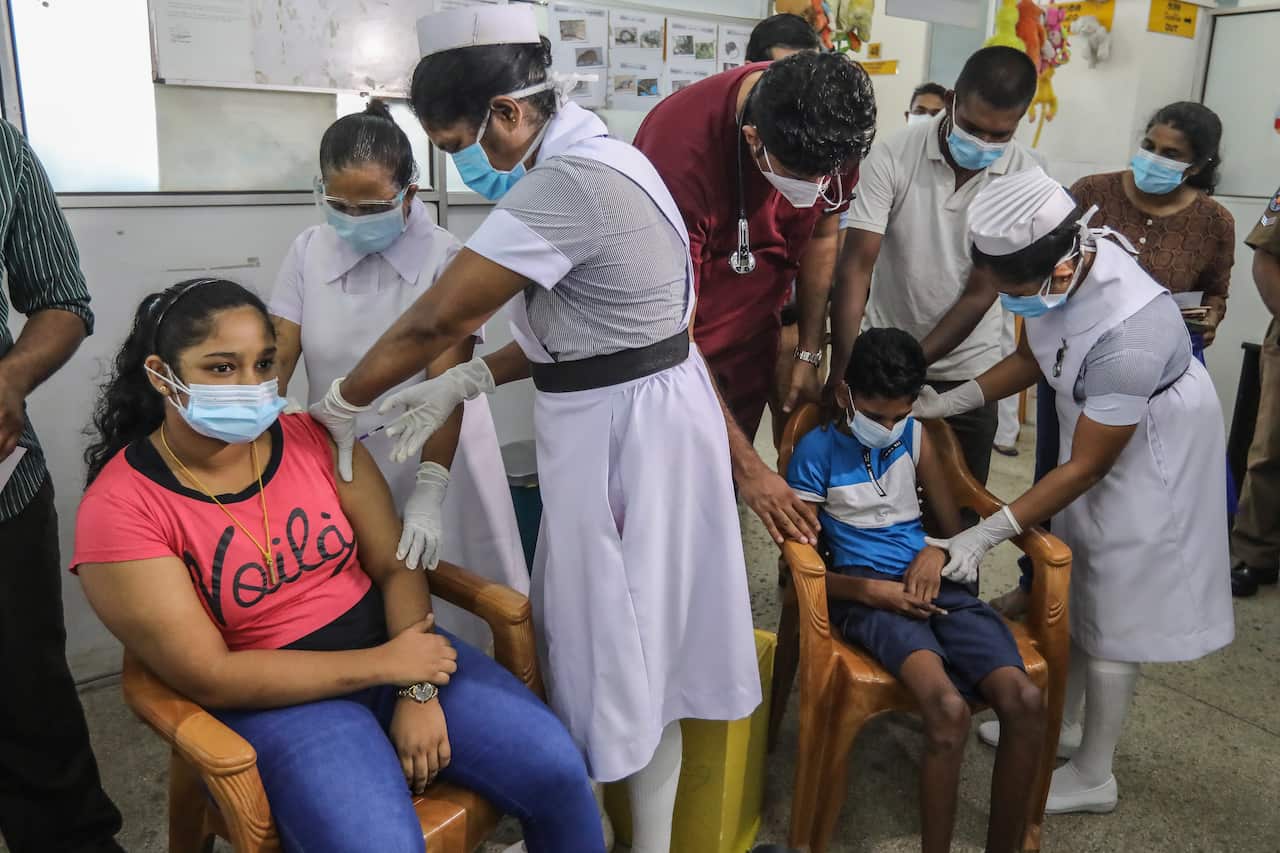 epa09485155 Hospital workers assisted by parents administer doses of COVID-19 vaccine to children at the Lady Ridgeway Children's Hospital in Colombo, Sri Lanka, 24 September 2021. With the Sri Lankan government deciding on vaccinating children between th