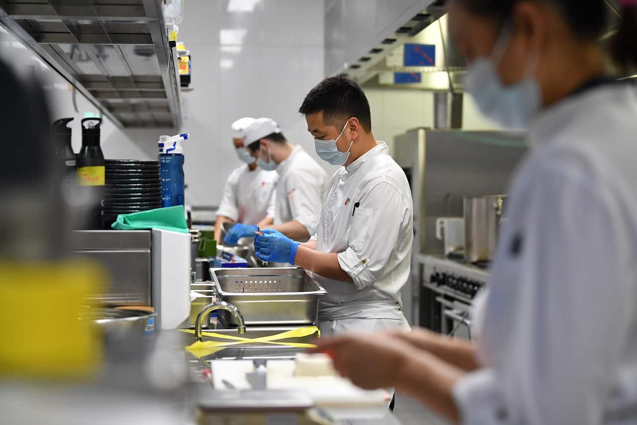 Workers prepare food at Japanese restaurant Nobu at Crown Sydney in Sydney, Sunday, October 10, 2021. 