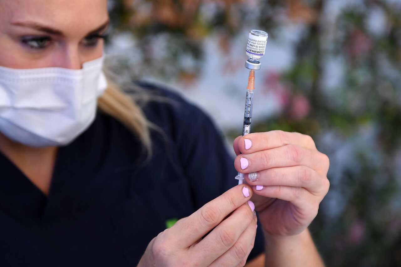 Nurse preparing a COVID-19 vaccine.