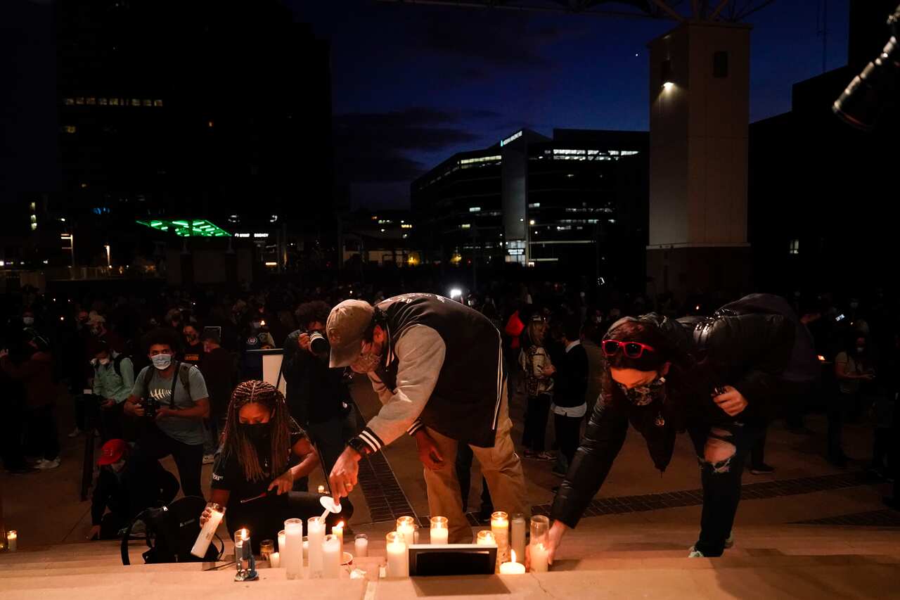 People light candles to honor cinematographer Halyna Hutchins during a candlelight vigil in Albuquerque, N.M., Saturday, Oct. 23, 2021. Hutchins died on Thursday after she wasfatally shot by actor Alec Baldwinwith a prop gun on a New Mexico film set. (AP