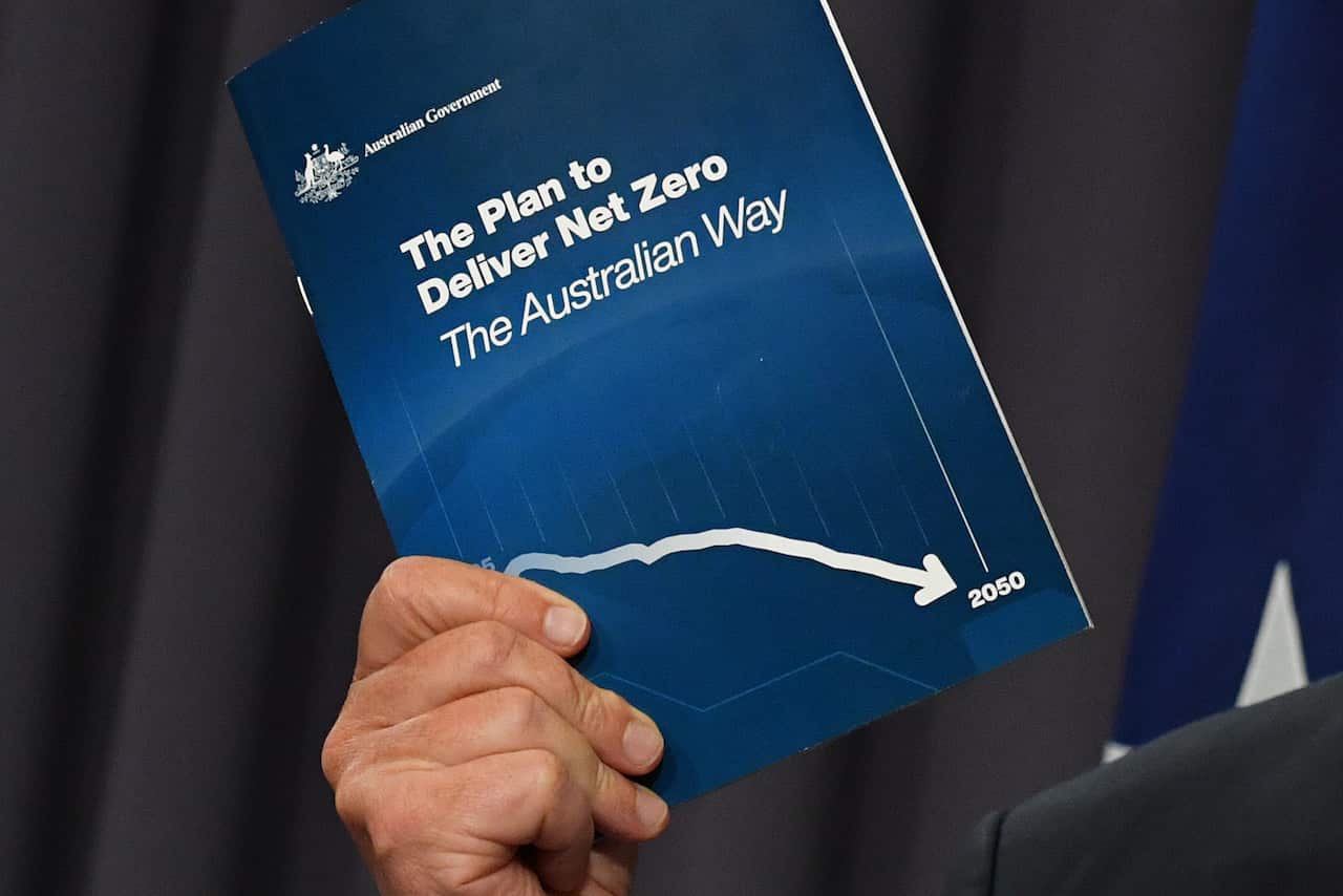 Prime Minister Scott Morrison holds his plan for net zero emissions during a press conference at Parliament House in Canberra, Tuesday, October 26, 2021. (AAP Image/Mick Tsikas) NO ARCHIVING